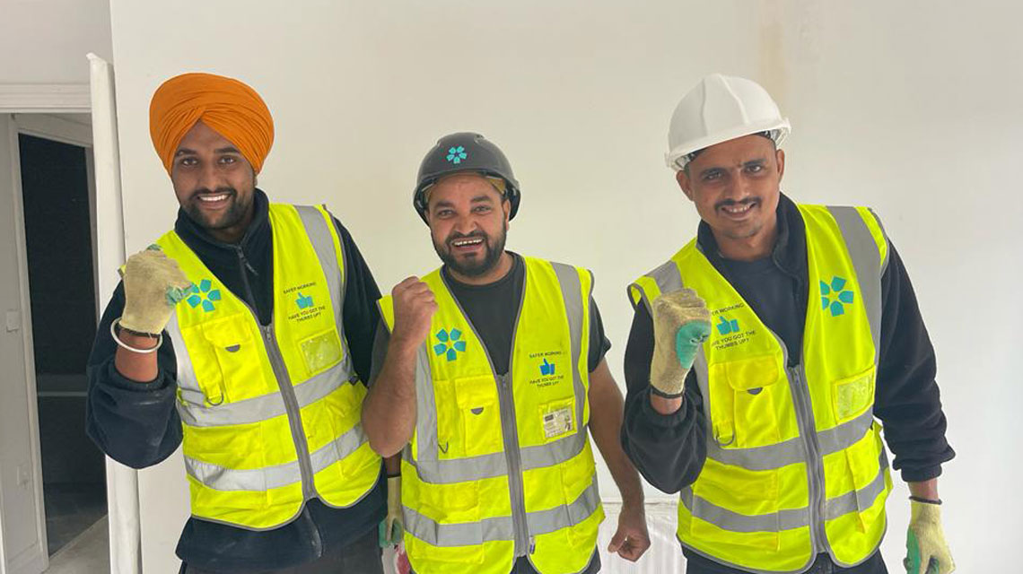 Foreman Chinder (center) welcomes Harinder and Majinder